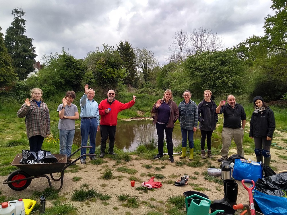 Volunteers posing for a group photo in fron of the algae free wildlife pond