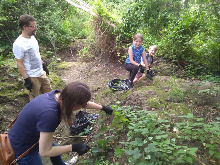 Family of volunteers removing variagated yellow archangel