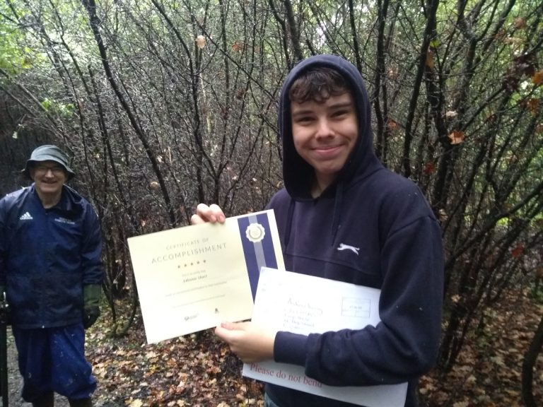 Volunteer posing eith certificate